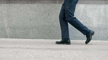 Business man legs dancing at street. Closeup shoes dancing outdoor near building