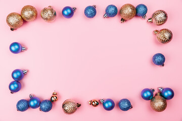 Christmas composition. Gold blue decorations on pastel pink background. Christmas, winter, new year concept. Flat lay, top view, copy space.