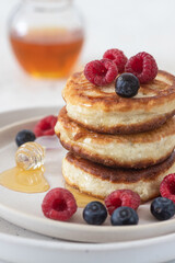 Pancakes with berries and honey