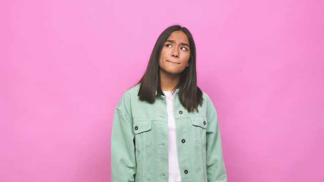 Young mixed race indian woman confused, feels doubtful and unsure