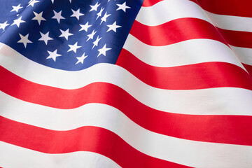 Close up of ruffled American flag. Satin texture curved flag of USA. Memorial Day or 4th of July....