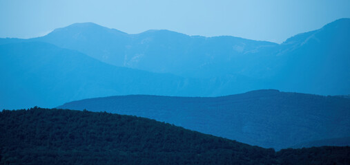Mountains in a blue haze. Background 