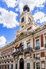 View of House of the Post Office (Real Casa de Correos) with Clock Tower - an eighteenth century (1768) building in Puerta del Sol, Madrid. Spain. - obrazy, fototapety, plakaty