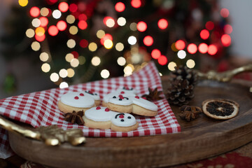Festive Christmas Cookie in the shape of a snowman on wooden tray
