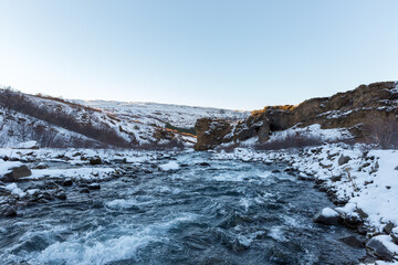Glacial river streaming in Icelandic winter