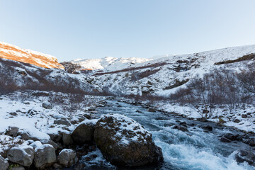 Fototapeta na wymiar River streaming from the Glymur waterfall in winter, Iceland