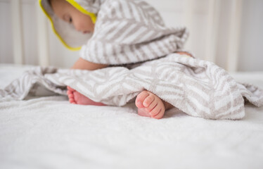 Fototapeta na wymiar baby's feet close up on a white bed