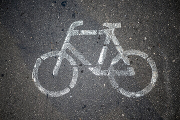 Bicycle or road sign. On asphalt. The view from the top.