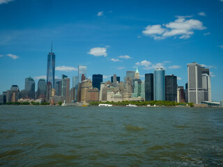 Naklejka premium Lower Manhattan of NYC New York City taken from liberty island. This also known as Downtown Manhattan the largest business district in state of New York and USA.