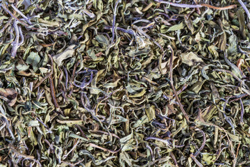 Heap of dried natural basil aromatic herbs. Macro