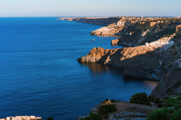 Summer seascape with Fiolent rocks formation on the coast of Sevastopol. view on cape in the sea, clear azure water, calm hot day. 