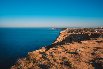 Obraz premium Summer seascape with Fiolent rocks formation on the coast of Sevastopol. view on cape in the sea, clear azure water, calm hot day. 