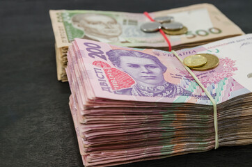 close-up of two bundles of hryvnia and coins. Financial concept. Ukrainian banknotes of 500 and 200 hryvnia. Lots of banknotes. Monetary concept.