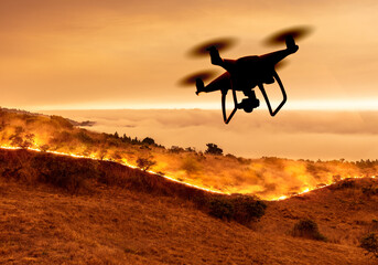 Drone flying over wildfire or forest fire on California coast