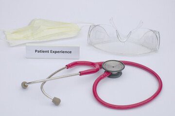 Patient Experience Concept with Stethoscope and Mask and Goggles nearby