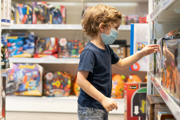 The child wears a protective mask in the store. Safety, health protection during COVID-19 quarantine