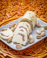 Oriental delight halva with pistachios on wooden background