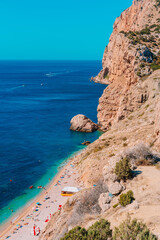 Panoramic view of the picturesque beach with white sand and azure water, top view of the beach vacationers, Crimea