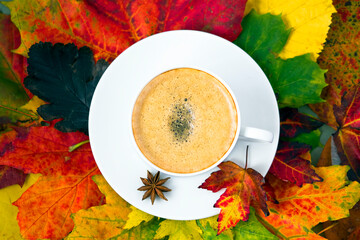 cup of coffee with autumn leaves