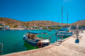 Fototapeta na wymiar Balaklava / Crimea - 20 Sep 2020: The yachts are located in a Bay with a view of the city and the azure water