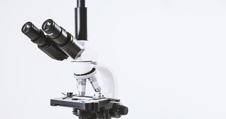 Using a biological microscope. Close up of a microscope. Scientific research concept, using a microscope. Medical examinations, searching for bacteria, diseases, blood tests.