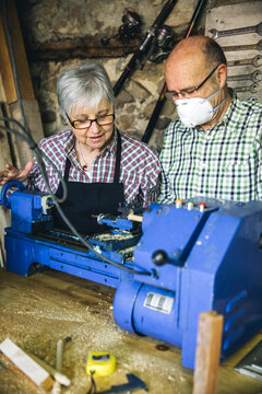 Senior couple working in a carpentry workshop