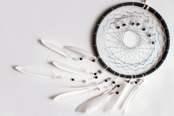 Dream catcher on a white background. Feather toy. Feather ring. Dreamcatcher amulet
