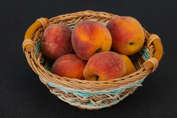 Peach heap in the wooden basket
