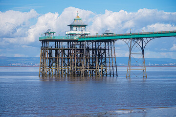 Panoramic photo of Clevedon Pier in somerset showing iron structure against blue sky