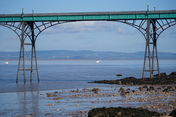 Panoramic photo of Clevedon Pier in somerset showing iron structure against blue sky