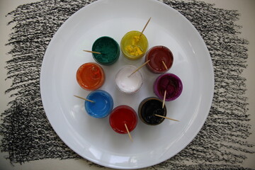 Set of gouache paint pots of different colors
