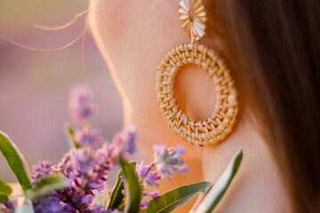 exquisite handmade earring in the shape of a circle on the ear of a young girl