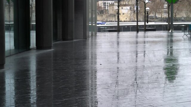 Shot of buildings reflection on wet pavement and citiscapes in background