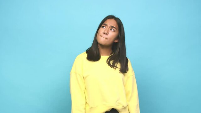 Young mixed race indian woman confused, feels doubtful and unsure