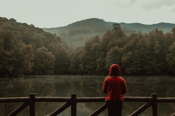 Fototapeta premium The Man Standing on Wooden Pier in Forest