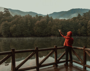 Fototapeta premium The Man Standing on Wooden Pier in Forest