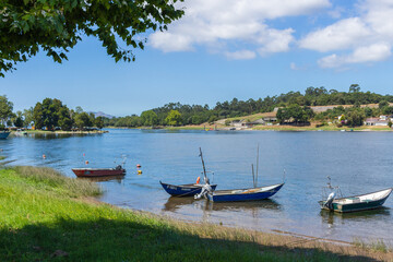Vila Nova de Cerveira / Portugal - August 1, 2020: Small fishing boats moored in the Minho River.