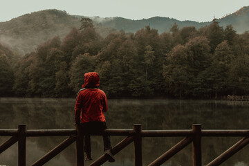 Fototapeta premium The Man Standing on Wooden Pier in Forest