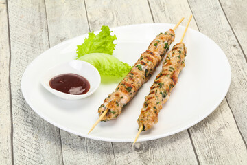 Minced pork skewer kebab with sauce