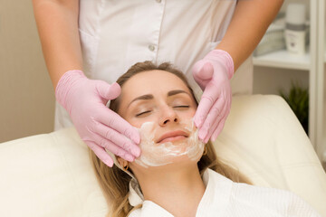 Obraz na płótnie Canvas stage of facial cleansing with foam at a cosmetologist's appointment