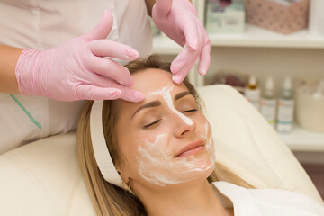 Obraz na płótnie Canvas stage of facial cleansing with foam at a cosmetologist's appointment