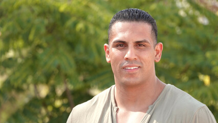 Outdoor portrait of young Hispanic man smiling for the camera