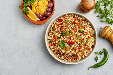 Bulgur pilaf with eggplant and vegetables. Top view with copy space