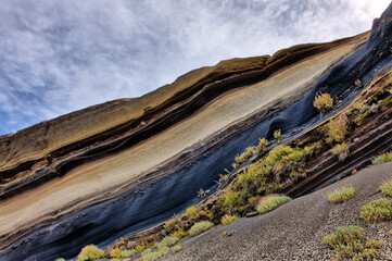At the Tarta del Teide viewpoint, there is an open eruption of rocks with layers of lava ash in...