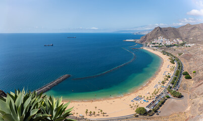 A white dream beach in the east of Tenerife near the village of San Andres. View from a lookout point over the coastline. Parts of the island's capital can be seen in the background.