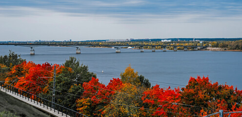 Autumn view of Kama River embankment in Perm. Communal bridge over Kama. 