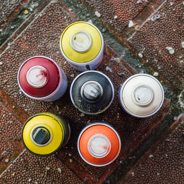Colorful spray paint cans on the ground