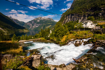 View of the river Geirangerelvi and the waterfall Storfossen in Geiranger, Norway.