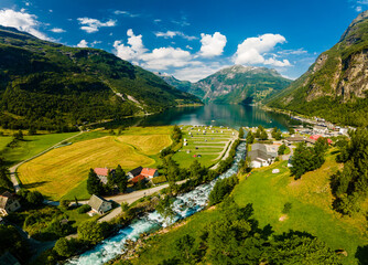 View of the river Geirangerelvi and the waterfall Storfossen in Geiranger, Norway.