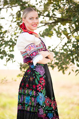 Young beautiful slovak woman in traditional costume. Slovak folklore.